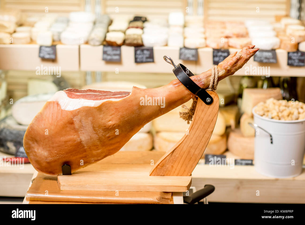 Prosciutto leg in ham holder on the table in the food store Stock Photo