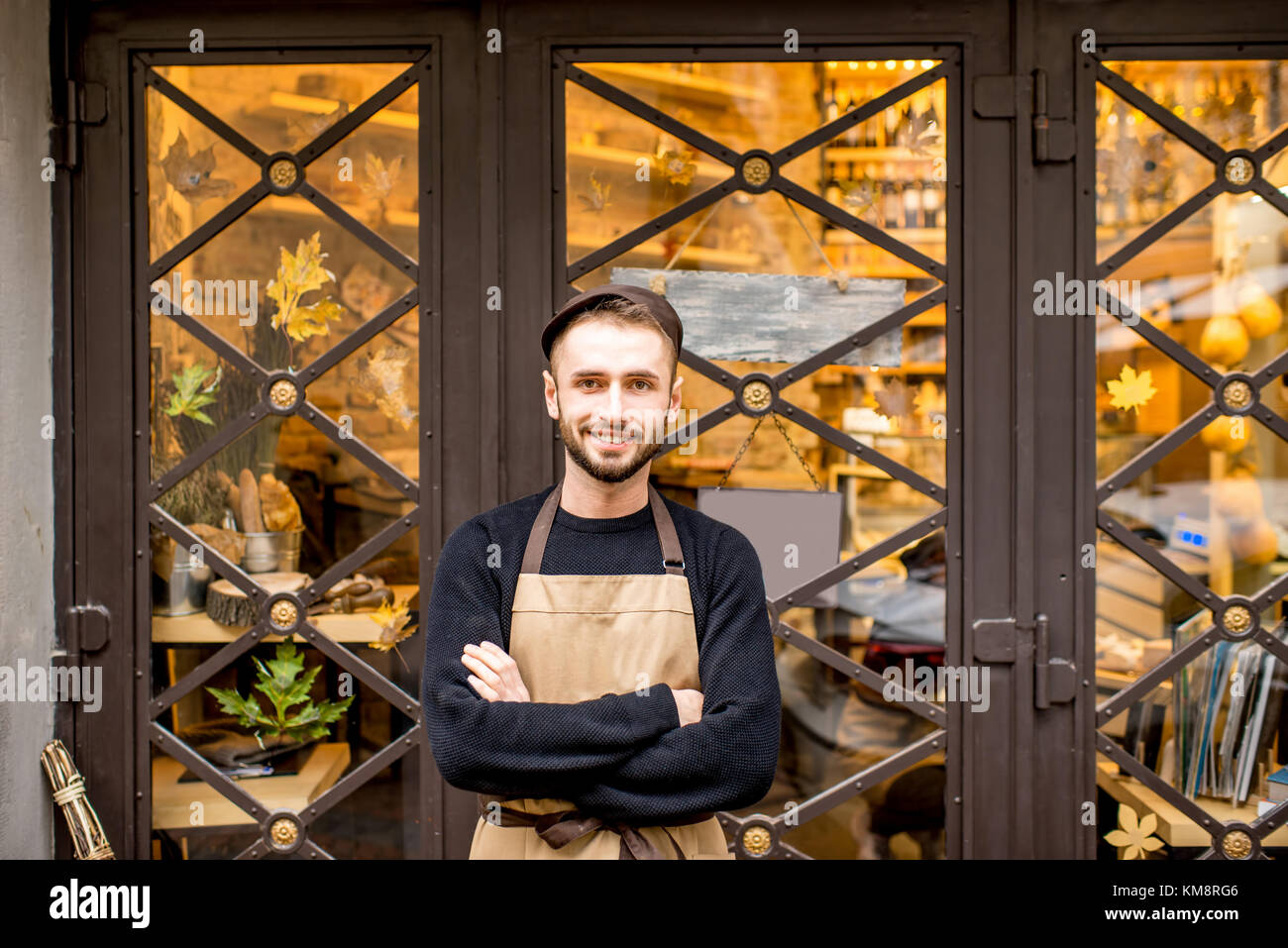 Portrait of a salesman in uniform outdoors in front of the store