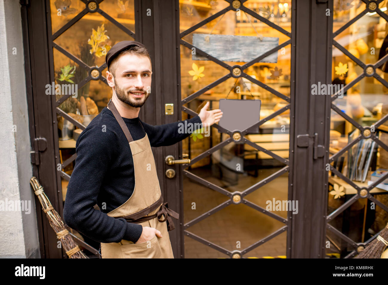 Portrait of a salesman in uniform outdoors in front of the store