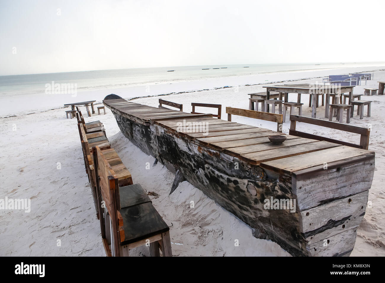 Wooden table and chairs on the beach. Furniture for lounging on Stock