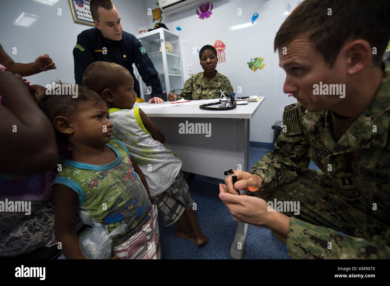 Lt. Gregory Condos, a U.S. Navy doctor, entertains a young boy from the