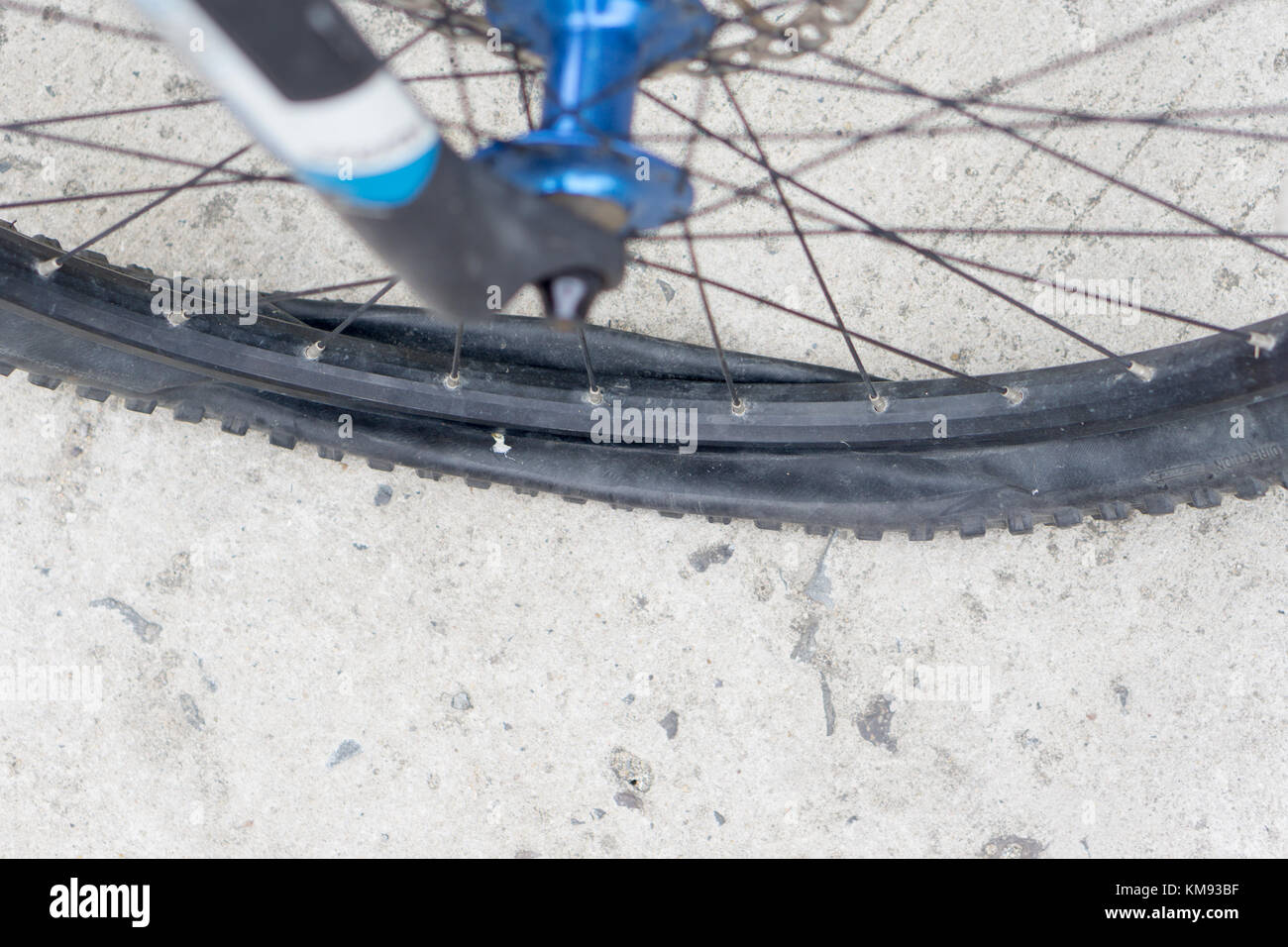 Closeup view of bicycle flat tire on pavement Stock Photo Alamy