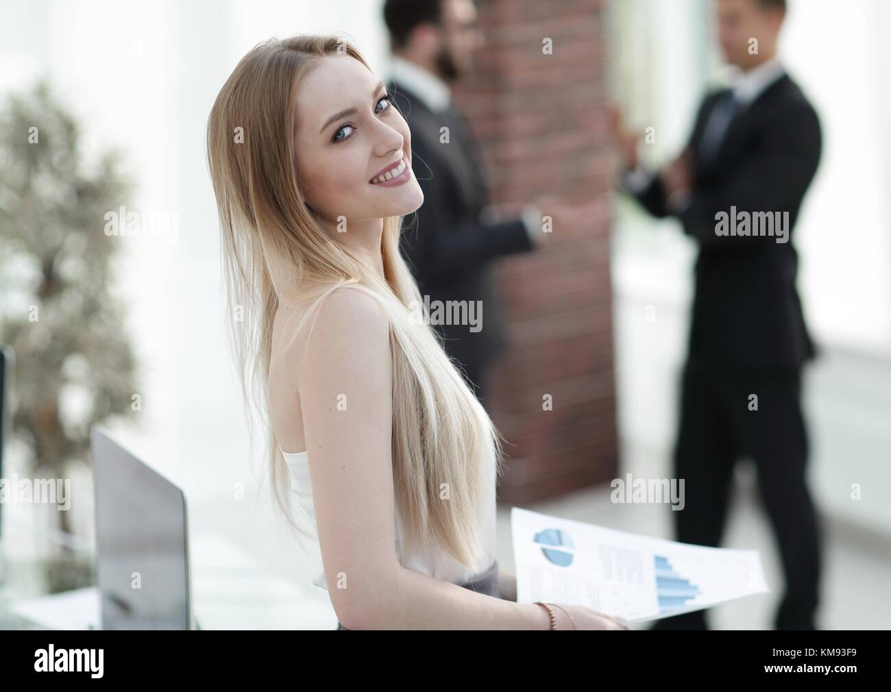 portrait of an elegant young business woman on the office background ...