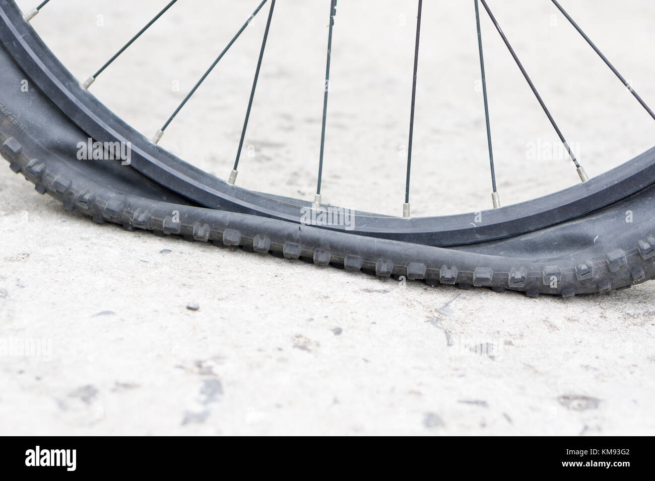 Closeup view of bicycle flat tire on pavement Stock Photo Alamy