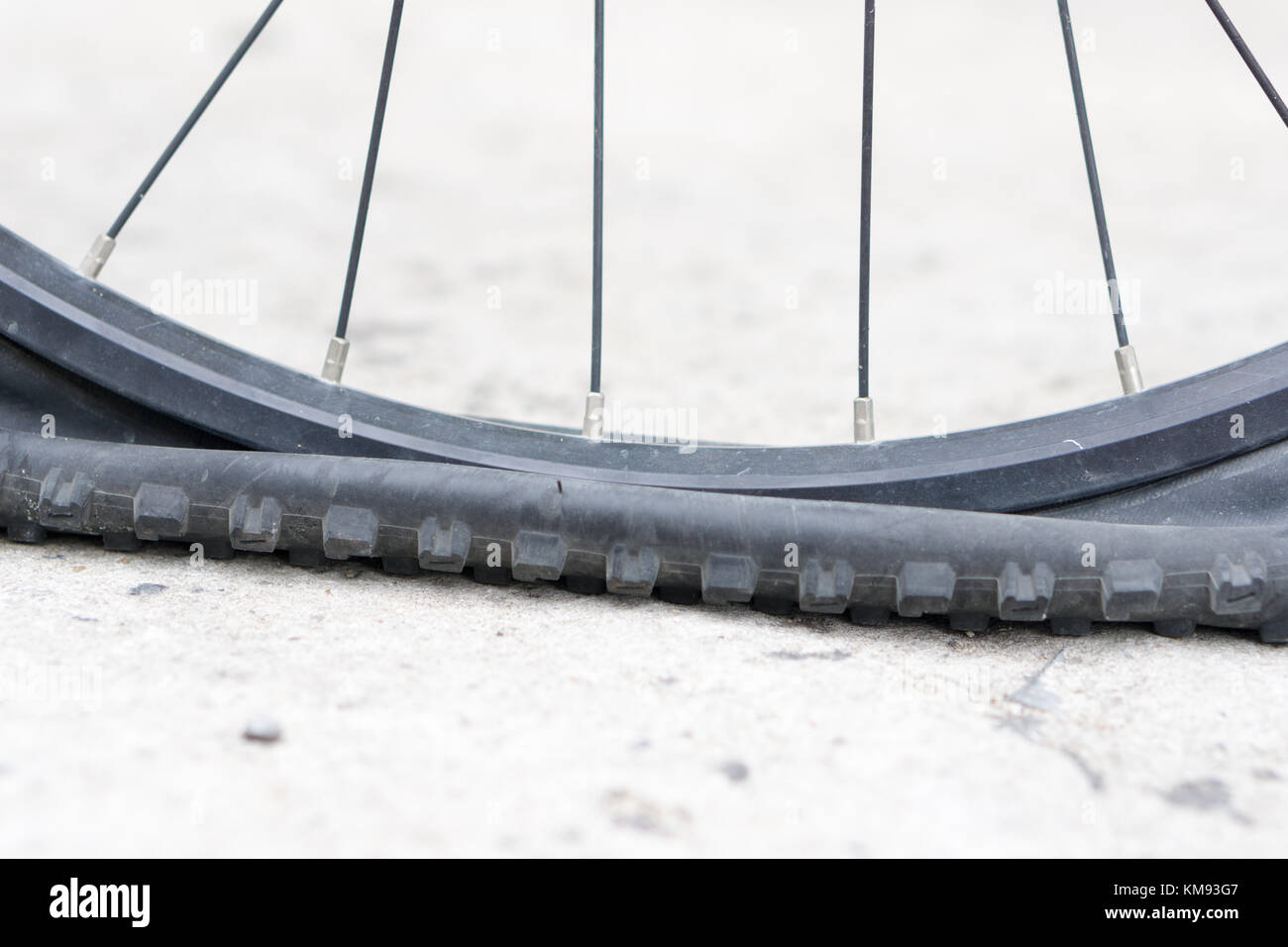 Closeup view of bicycle flat tire on pavement Stock Photo Alamy
