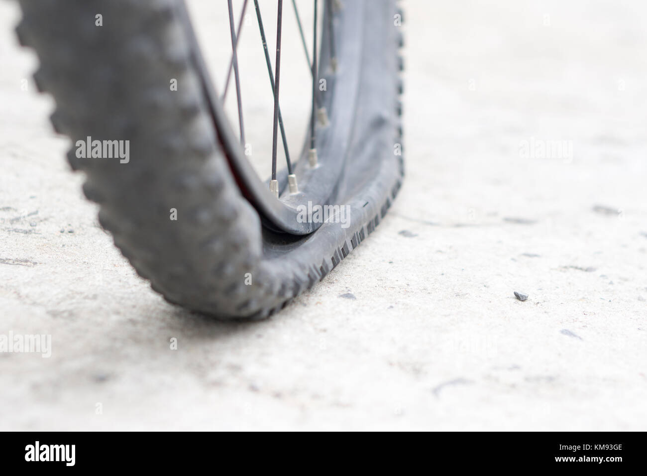 Closeup view of bicycle flat tire on pavement Stock Photo Alamy