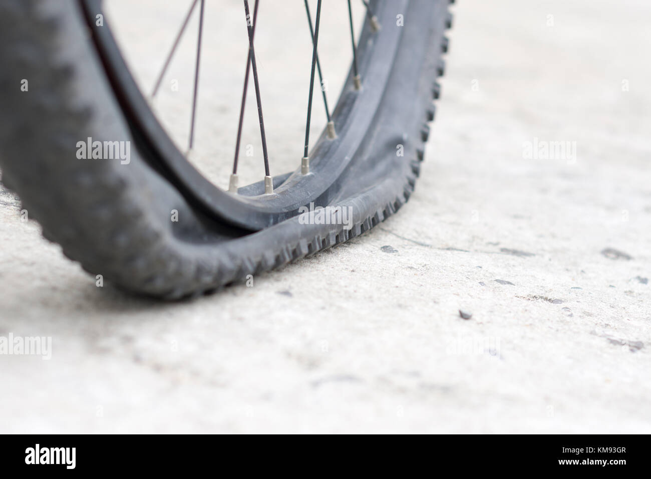 Closeup view of bicycle flat tire on pavement Stock Photo Alamy