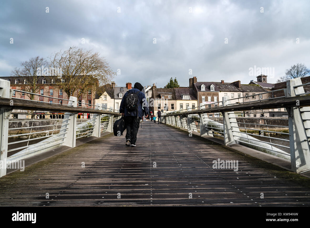 Beggar crossing a bridge in Cork Stock Photo