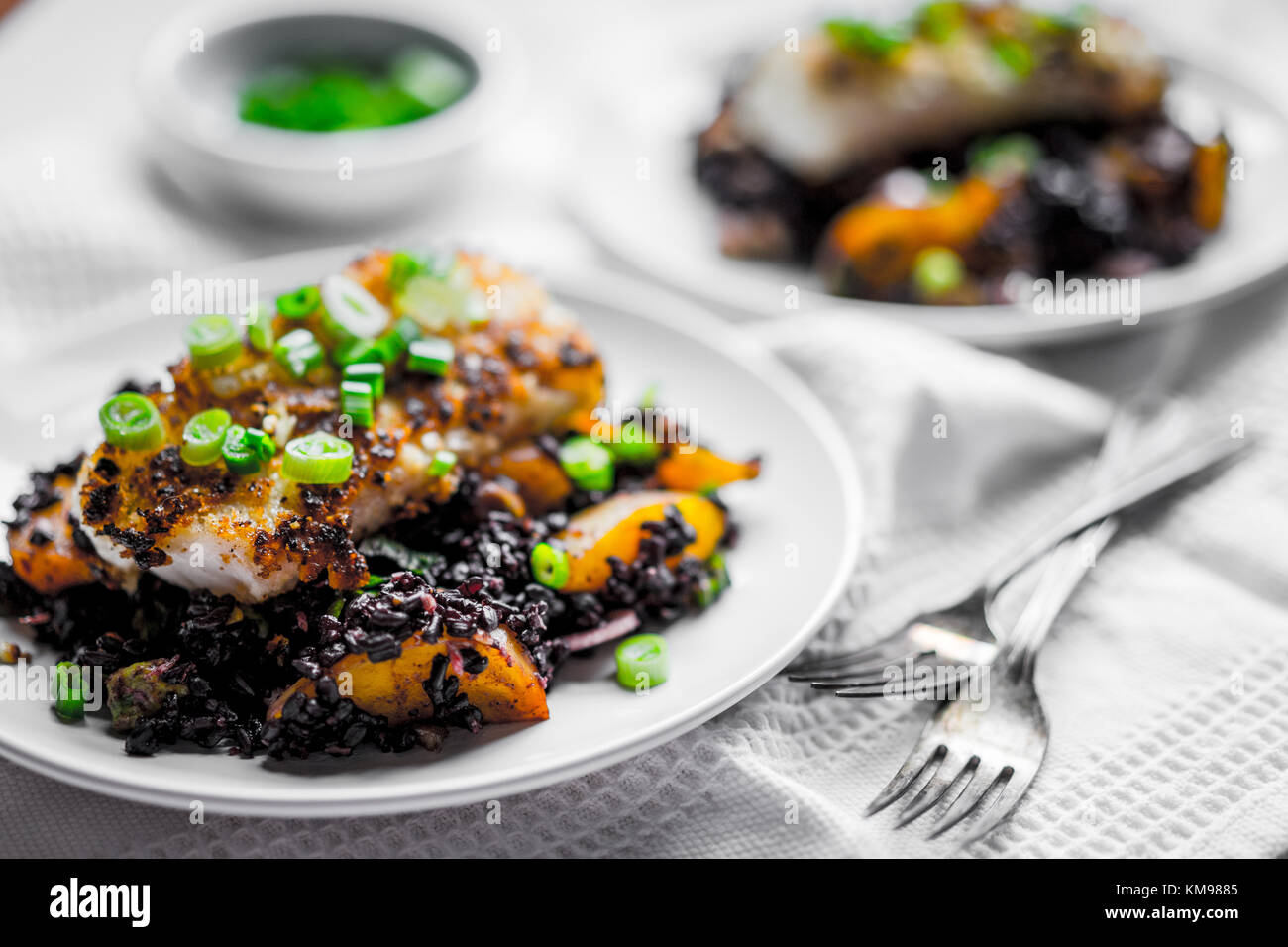 Grilled fish with black rice Stock Photo - Alamy