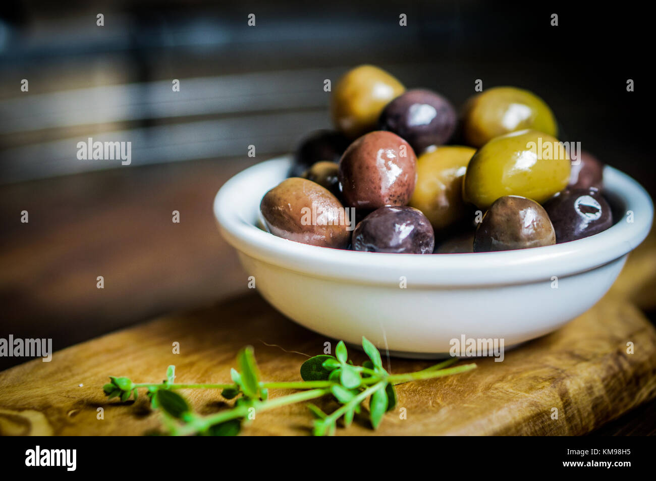 Olives On Rustic Wooden Background Stock Photo - Alamy