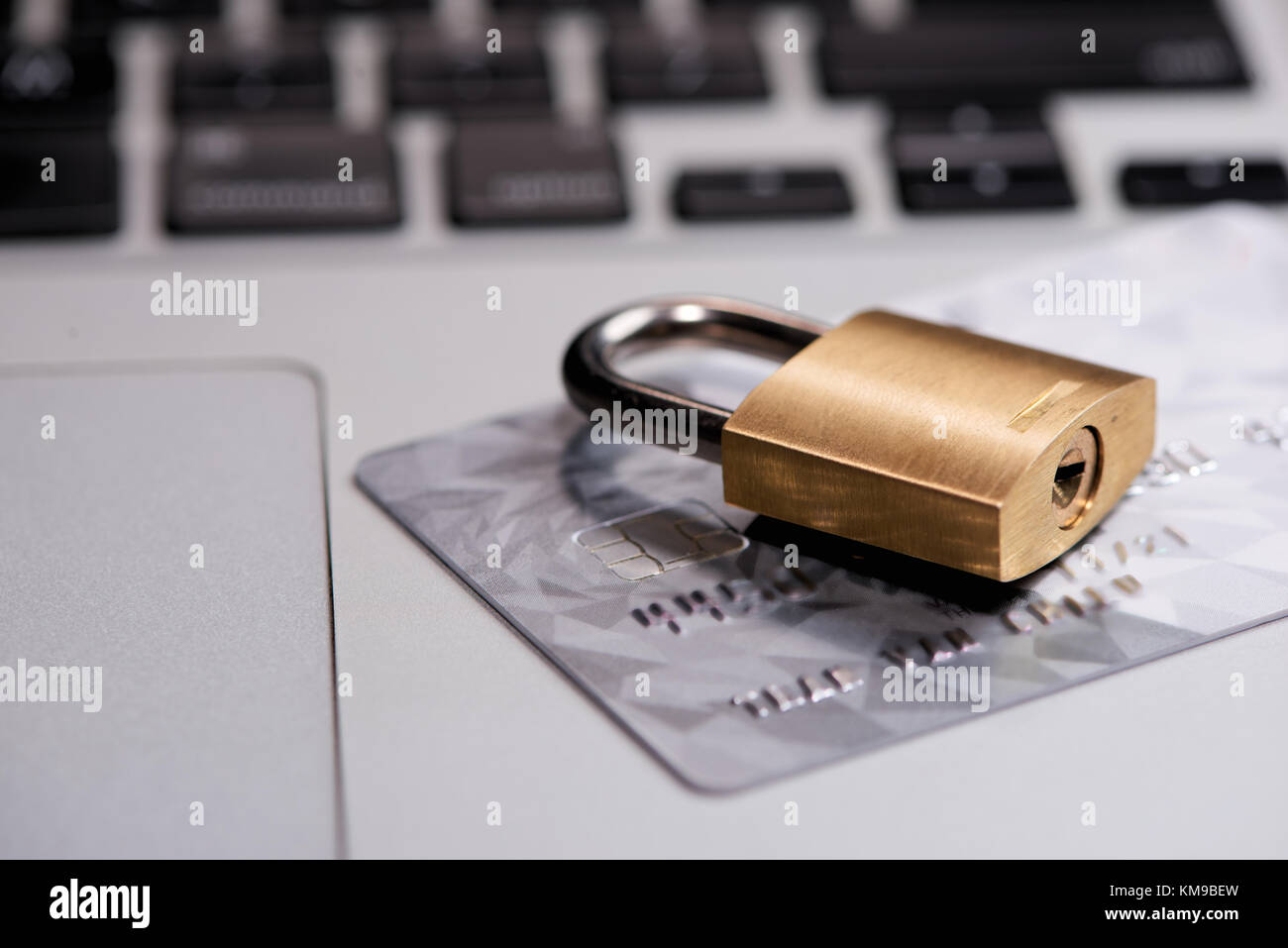 Credit cards on the keyboard with lock close up Stock Photo Alamy