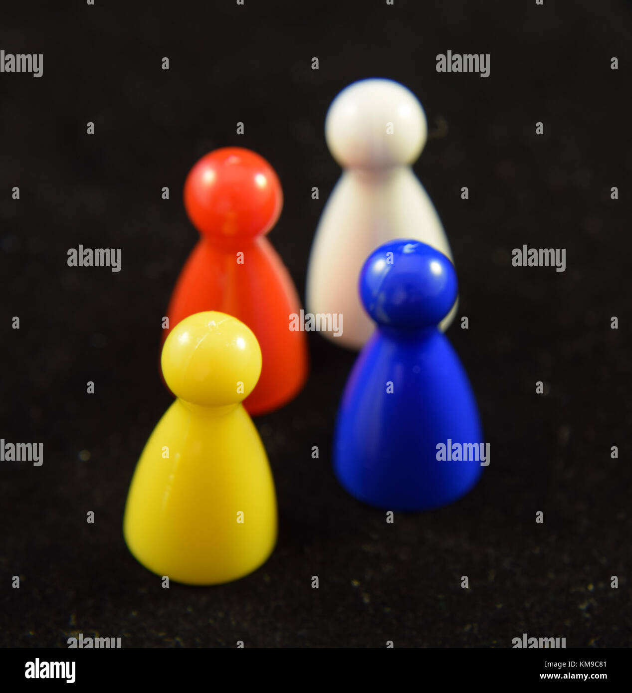 Four colourful Game counters or playing pieces frm a child's game Stock