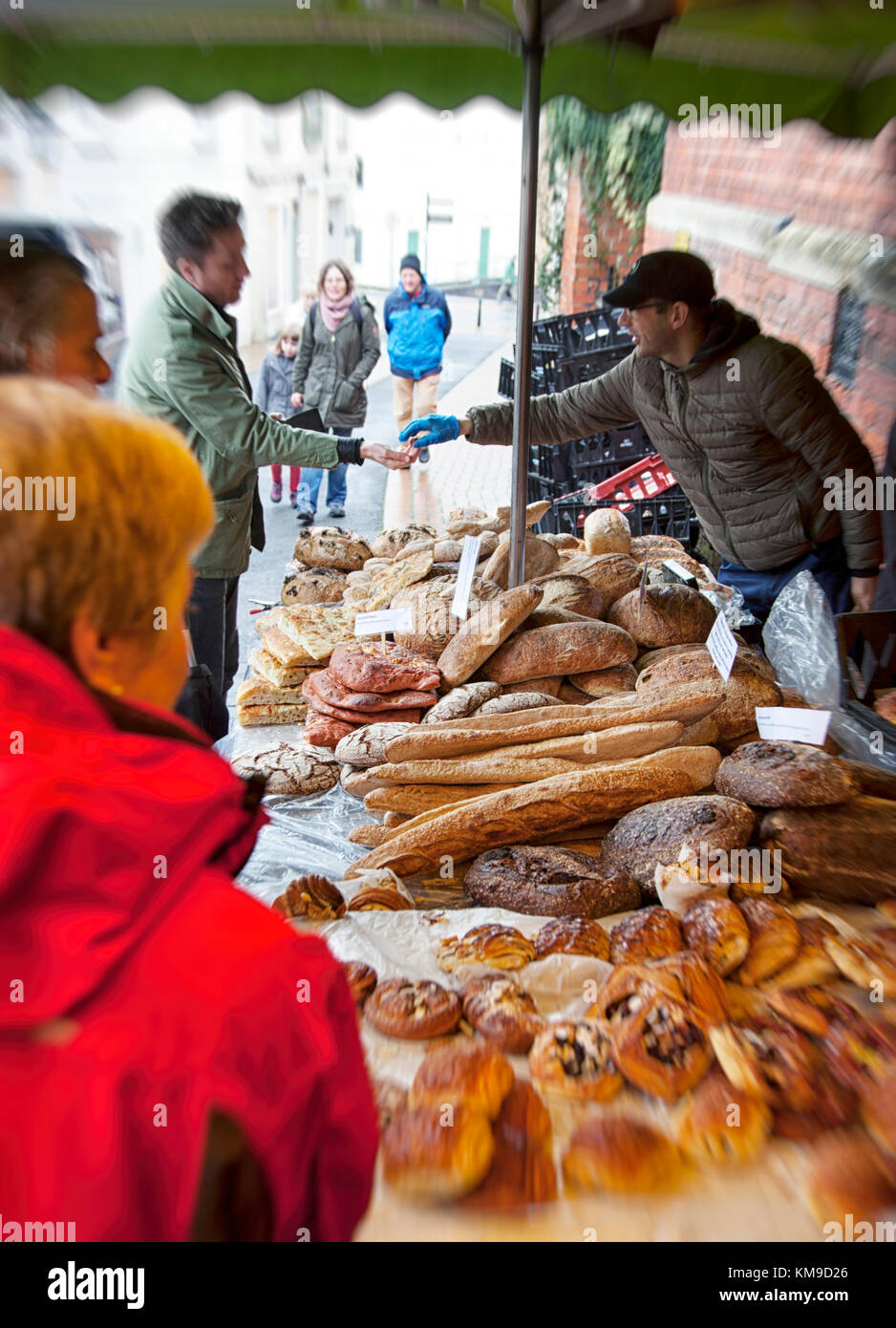 A busy artisan bakers stall with unusual sour dough breads at the award winning  Farmers Market in Stroud, Gloucestershire, UK Stock Photo