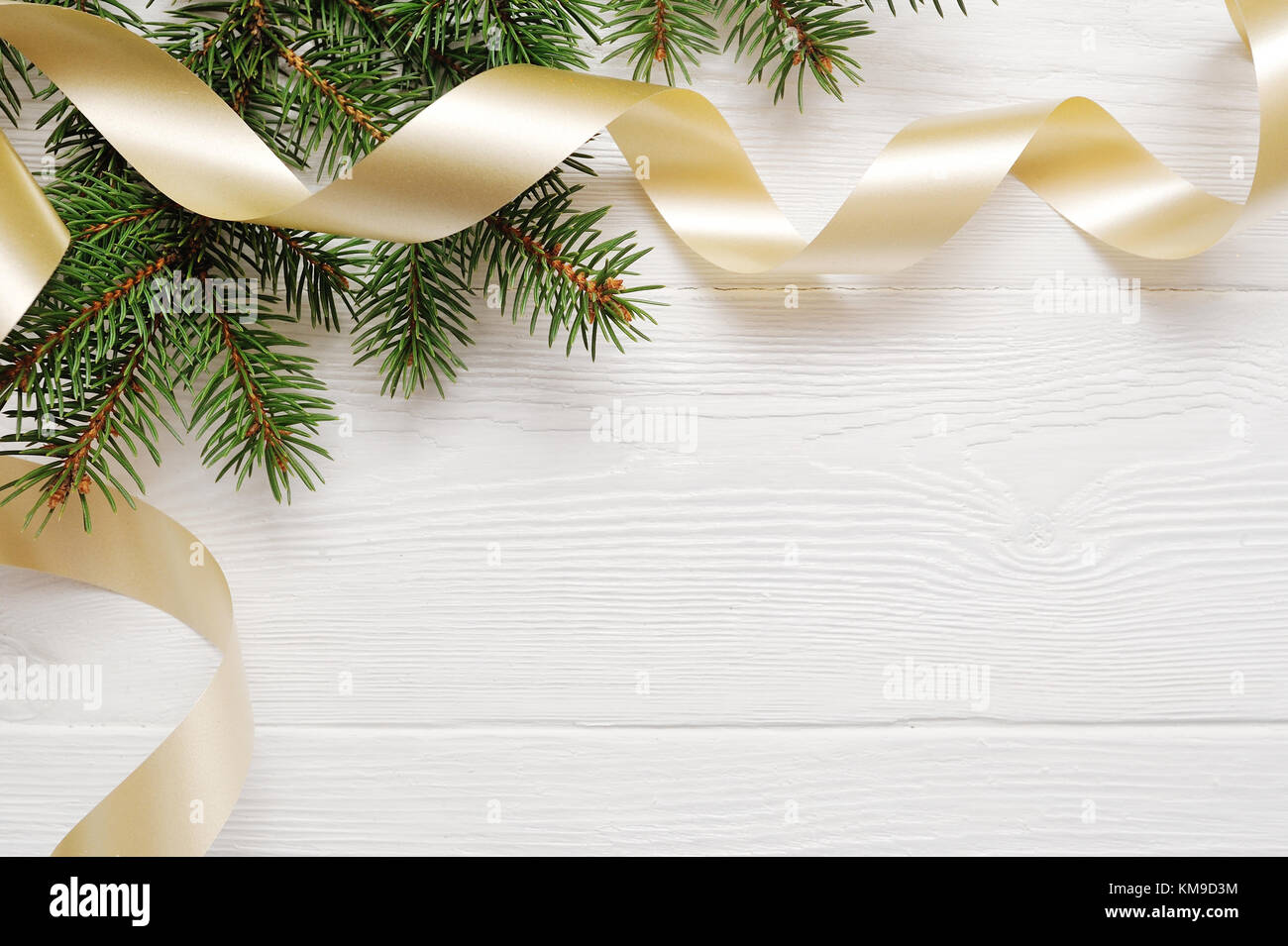 Mockup Christmas tree and gold ribbon, flatlay on a white wooden background, with place for your text Stock Photo
