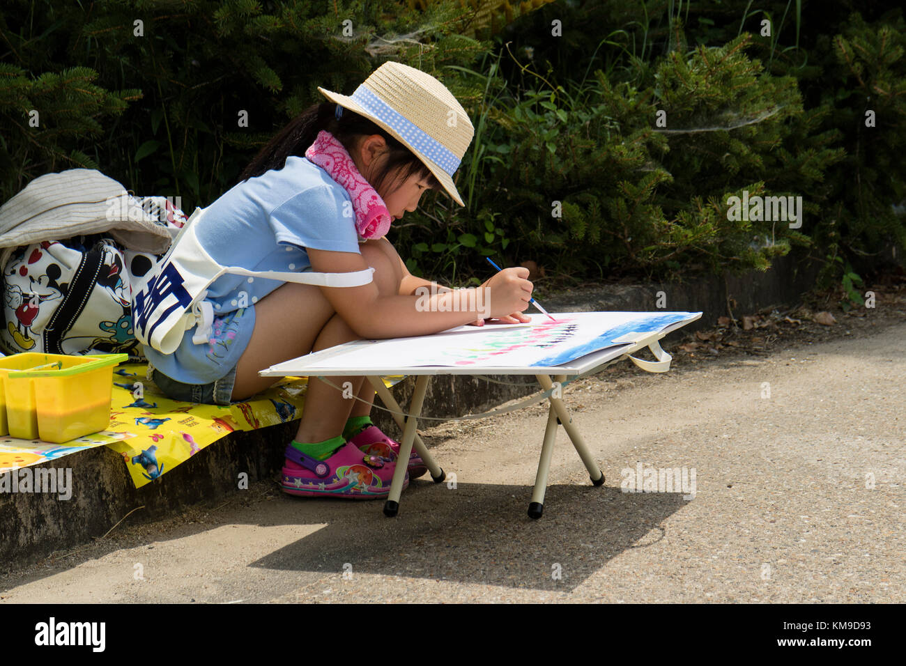 Kyoto, Japan - May 21, 2017: Child is painting in the Kyoto botanical garden to learn the shape of flowers and plants Stock Photo