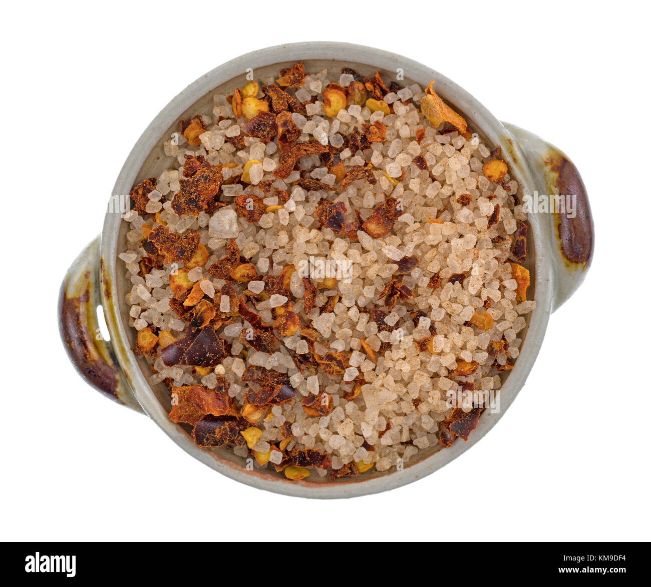 Top view of a small ceramic bowl filled with salt, red chili and paprika Greek spice rub