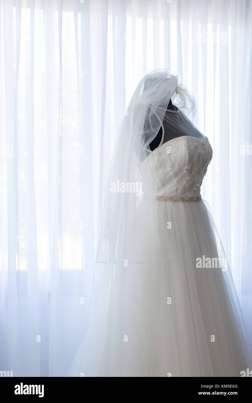 Bridal dress and veil on a dressmaker's model Stock Photo