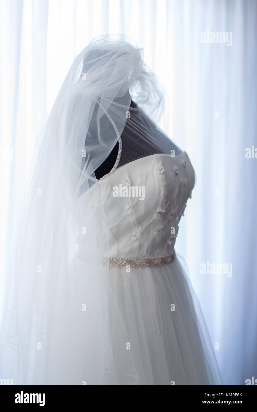Bridal dress and veil on a dressmaker's model Stock Photo