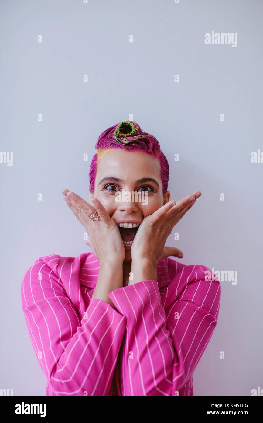 Portrait of a woman with pink hair in a pink shirt Stock Photo