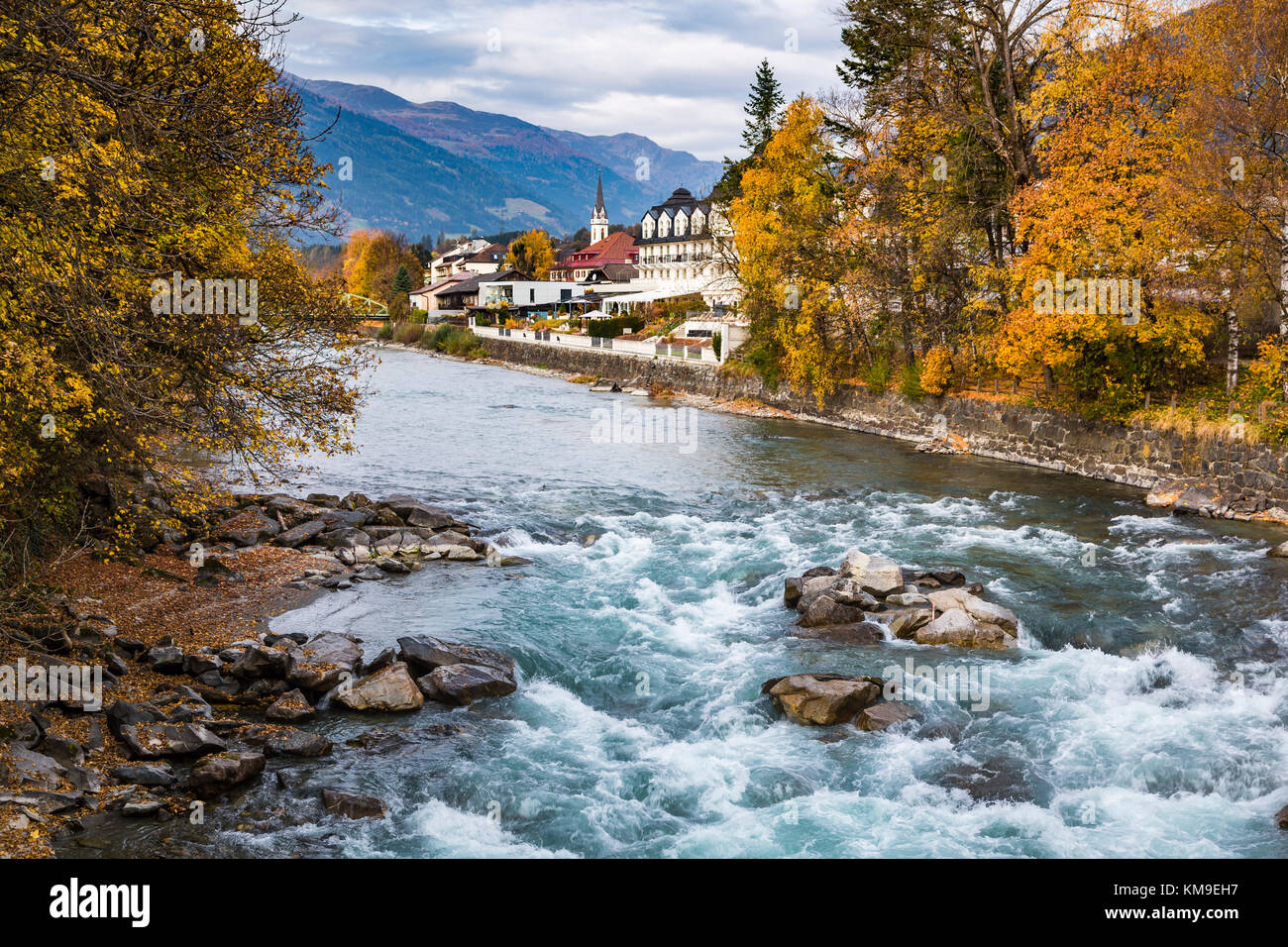 The Drava River with fall foliage color in Lienz, East Tyrol, Austria