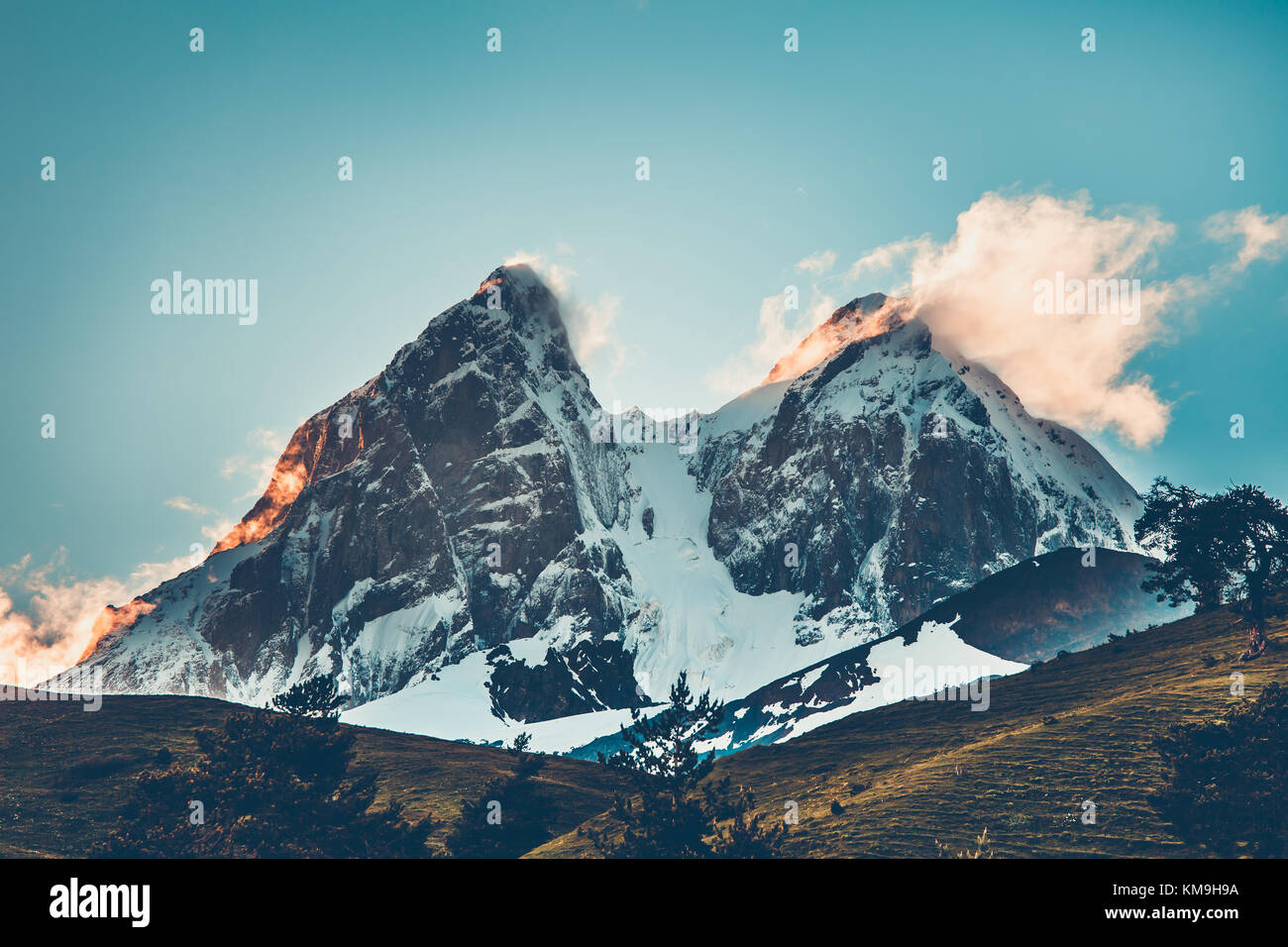 Sunset evening view over the snowy mountain peak Stock Photo - Alamy