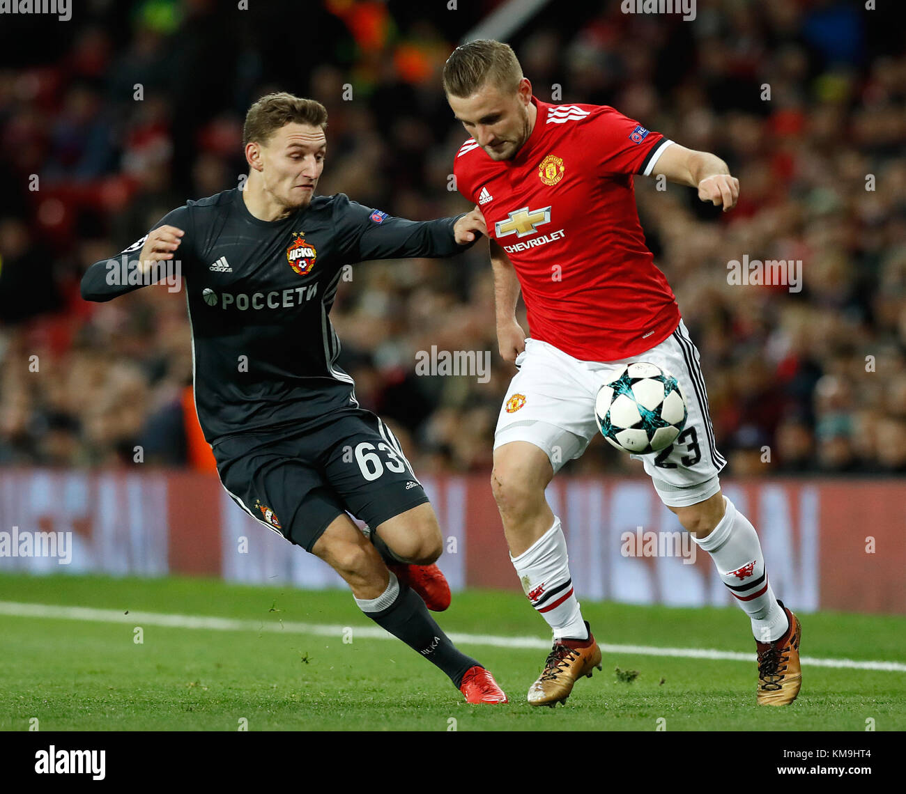 CSKA Moscow's Fedor Chalov (left) and Manchester United's Luke Shaw in action during the UEFA Champions League match at Old Trafford, Manchester. Stock Photo