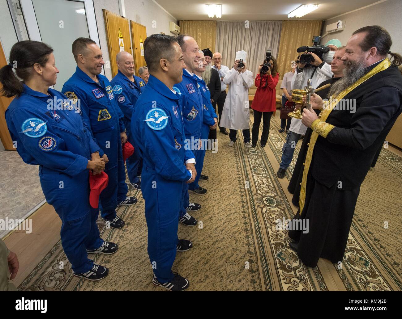 A Russian Orthodox priest blesses NASA International Space Station Expedition 53 prime and backup crew members (front, L-R) American astronaut Joe Acaba, Russian cosmonaut Alexander Misurkin of Roscosmos, American astronauts Mark Vande Hei, (back, L-R) Shannon Walker, Russian cosmonaut Anton Shkaplerov and American astronaut Scott Tingle before their launch aboard the Soyuz MS-06 spacecraft at the Cosmonaut Hotel September 12, 2017 in Baikonur, Kazakhstan.  (photo by Bill Ingalls via Planetpix) Stock Photo