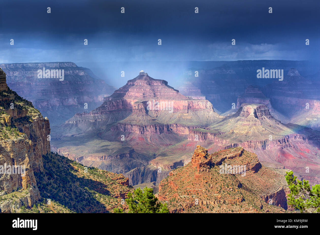 Rain over the Grand Canyon formations with ever changing light Stock Photo