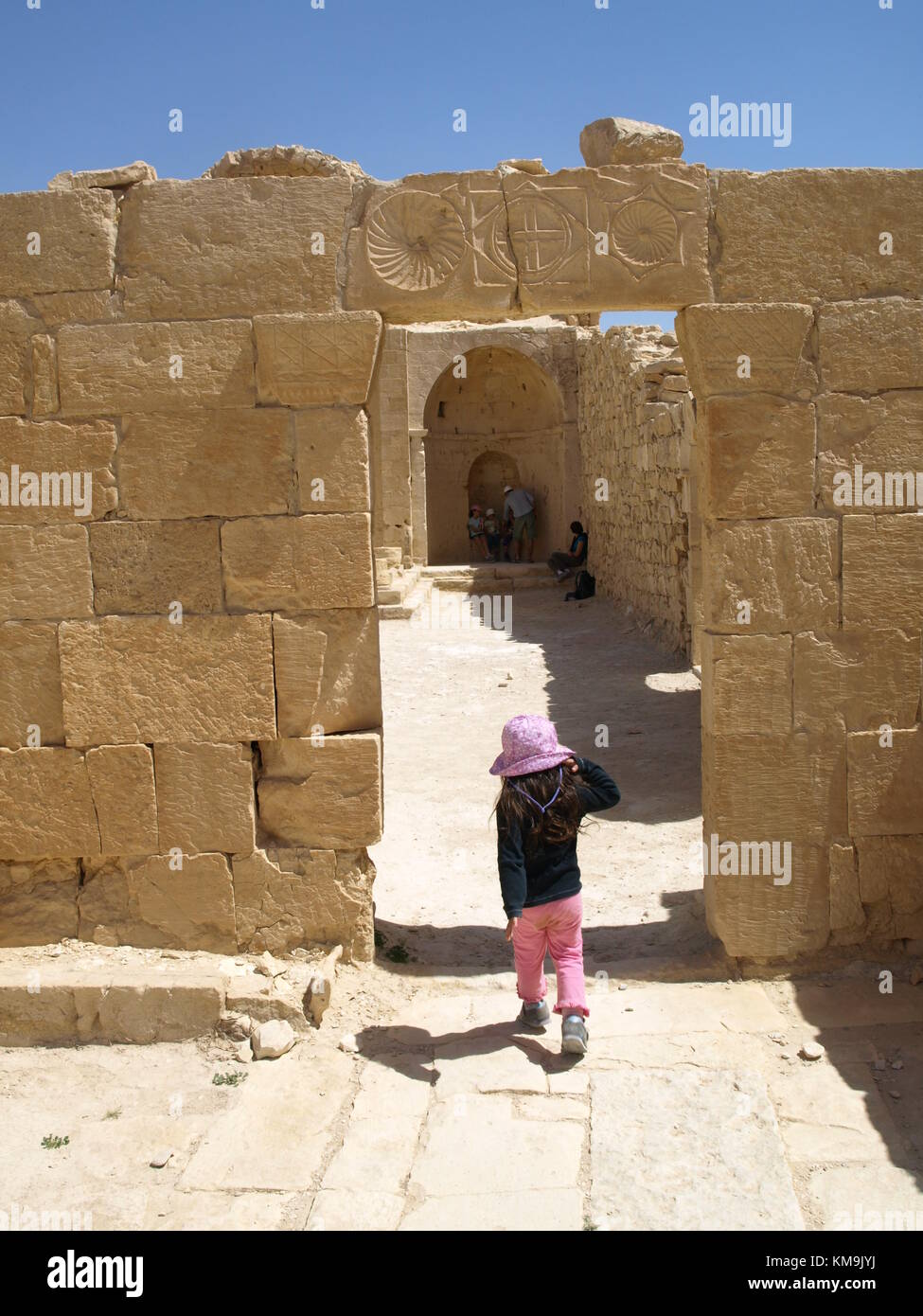 a child at the doorway is entering an Ancient city remains Stock Photo