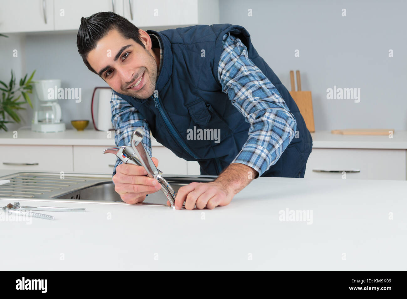 Portrait of plumber fitting kitchen tap Stock Photo Alamy