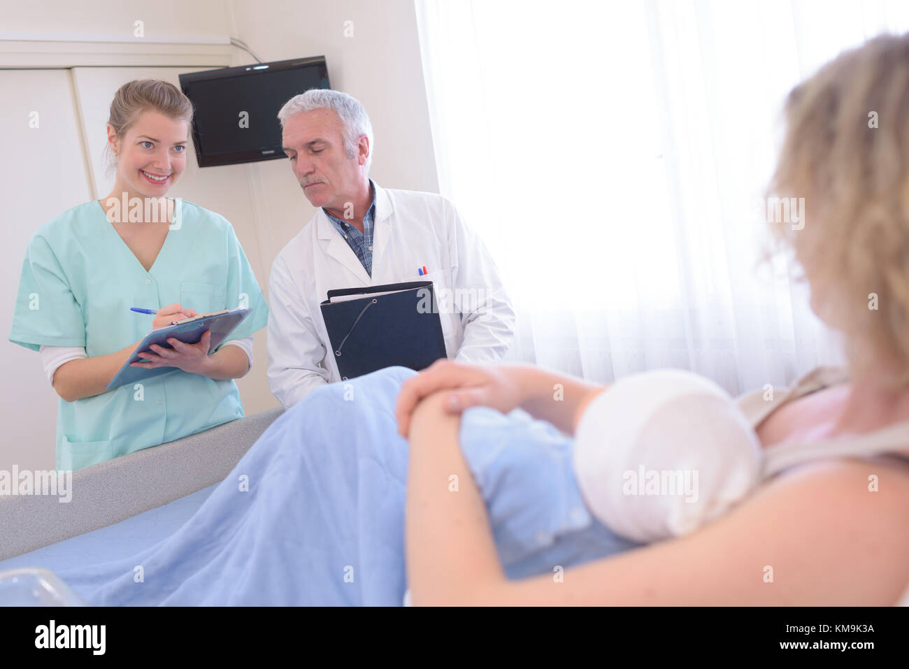 newborn baby in delivery room with mum doctor nurse Stock Photo
