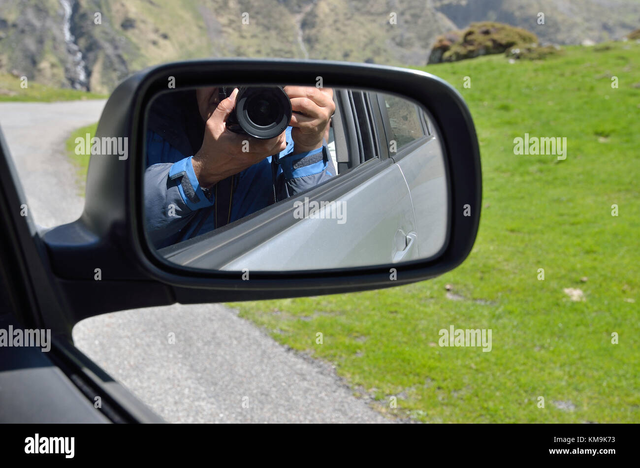 Wing mirror showing a camera in human hands Stock Photo Alamy