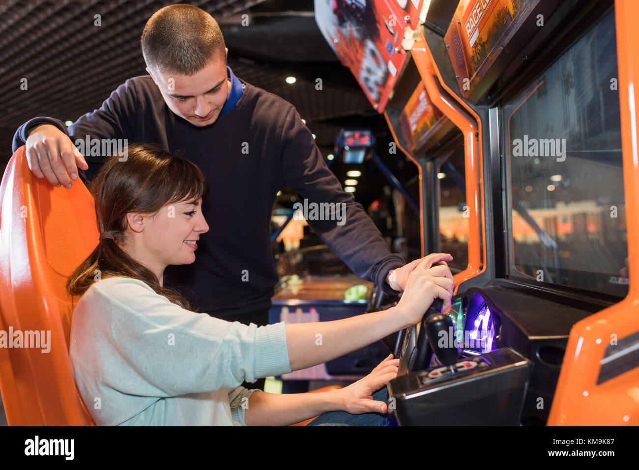 Young couple at arcade driving game Stock Photo