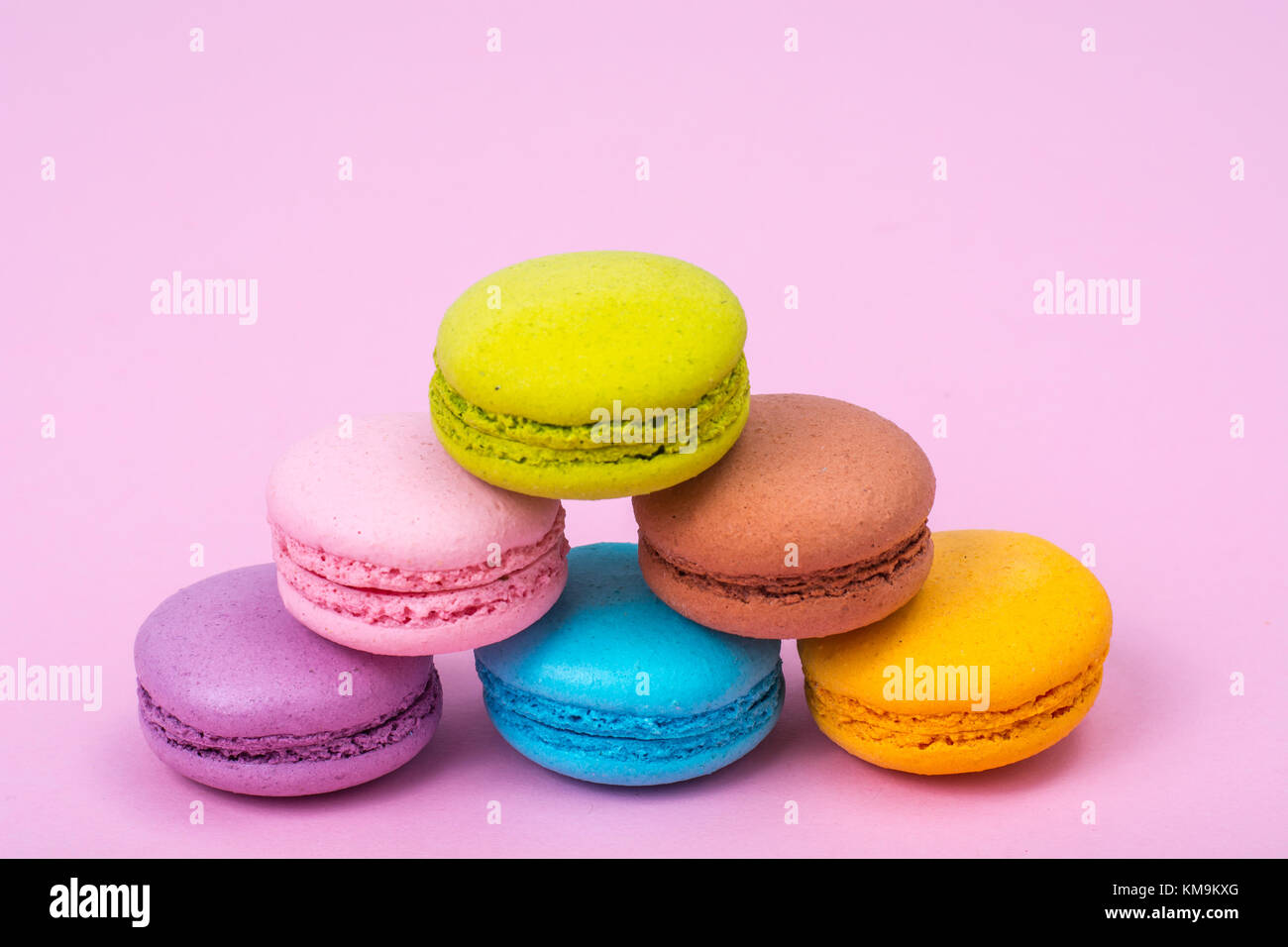 Small Macaroon Small French macaroons on pastel background. Studio Photo Stock Photo ...