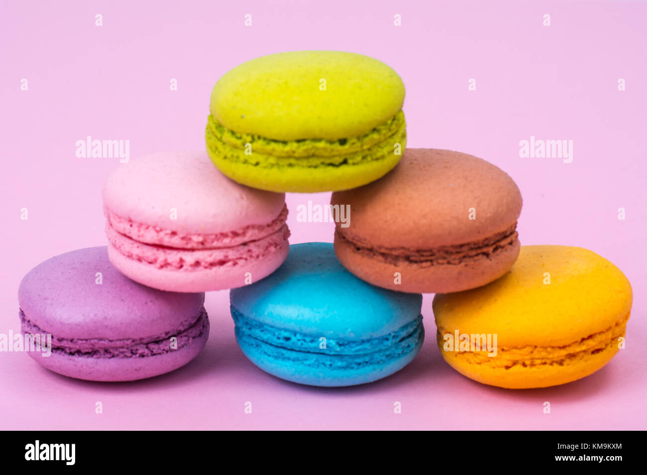 Small Macaroon Small French macaroons on pastel background. Studio Photo Stock Photo ...