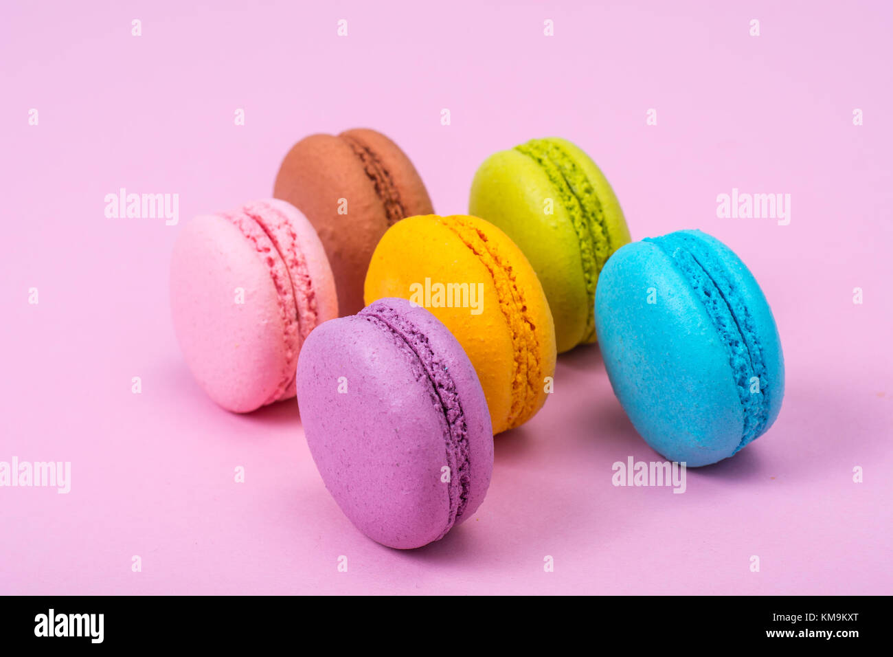 Small Macaroon Small French macaroons on pastel background. Studio Photo Stock Photo ...