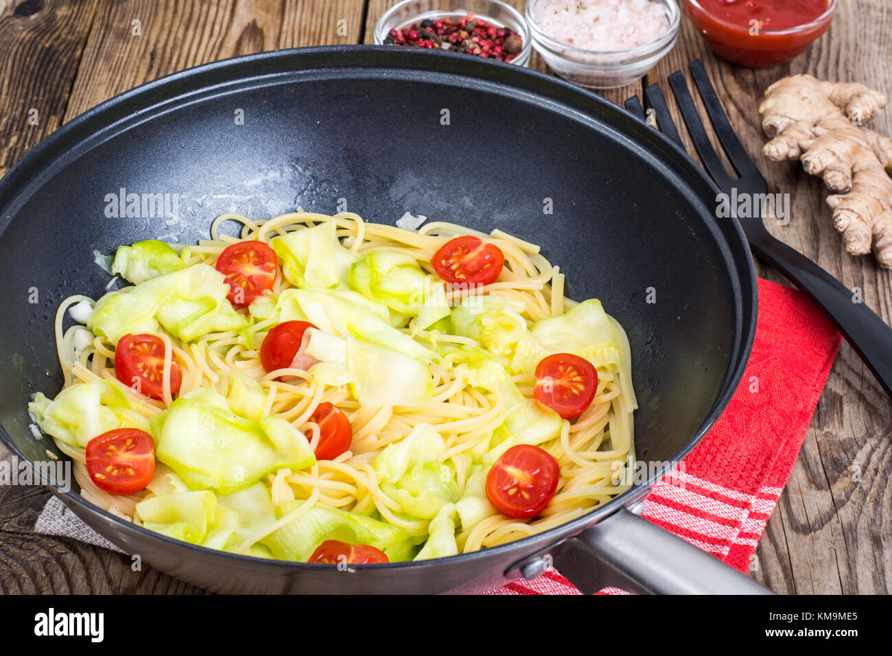 Frying pan wok with spaghetti with vegetables. Studio Photo Stock Photo