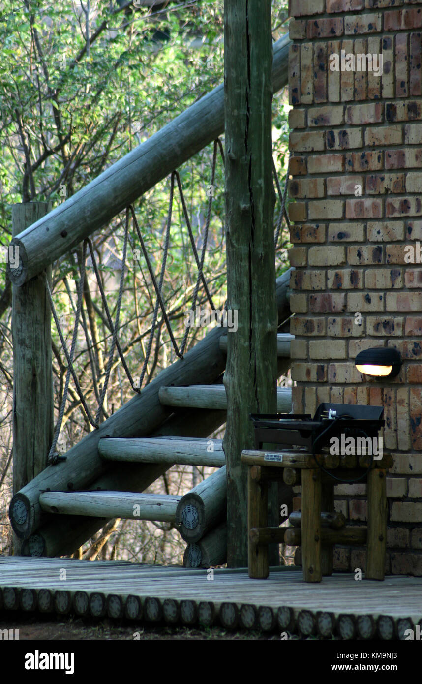 Kruger National Park, Marloth Park, wooden stairs, handrail, deck and table with rope banister Stock Photo