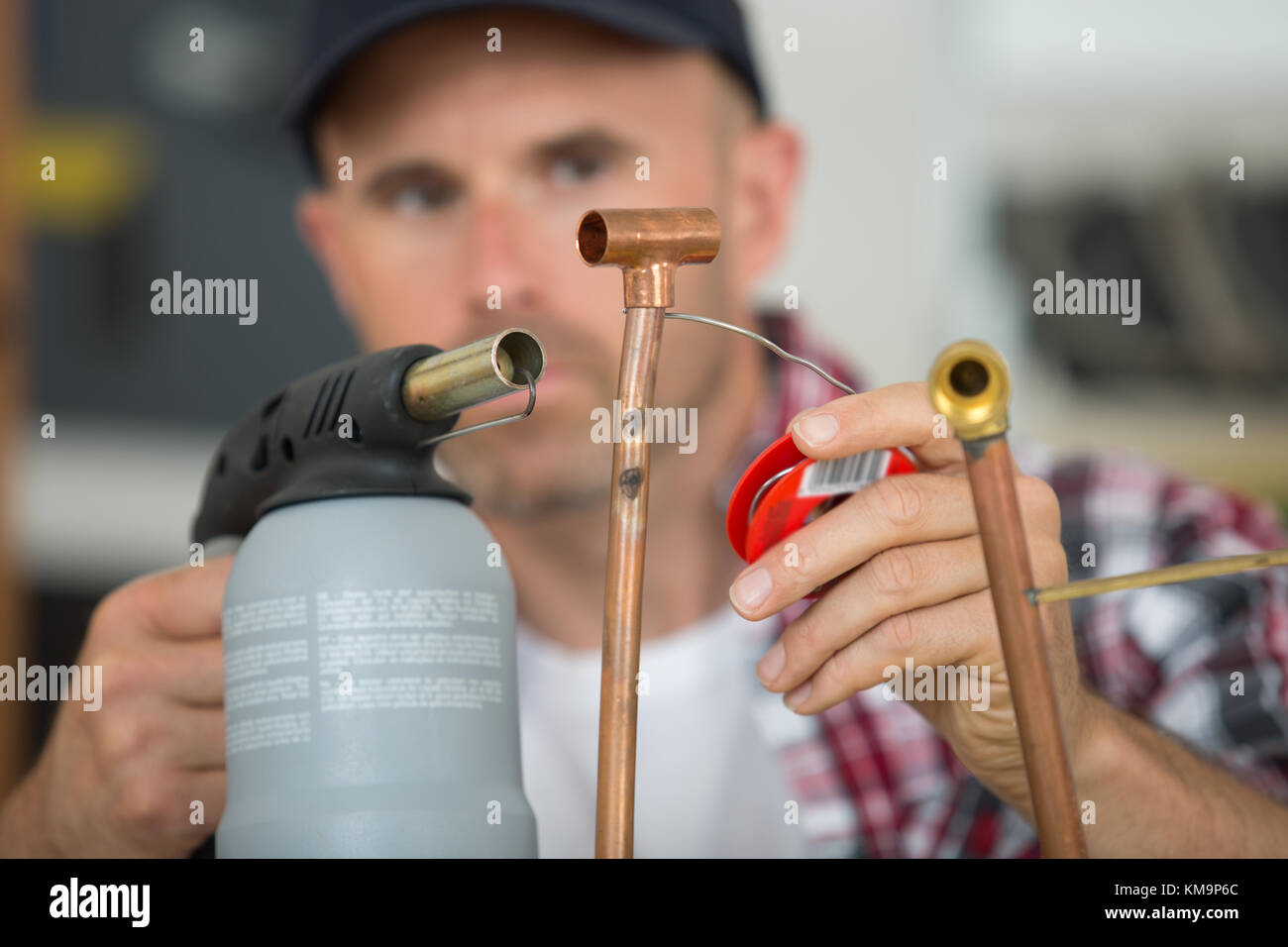 Tradesman soldering with blow torch Stock Photo Alamy