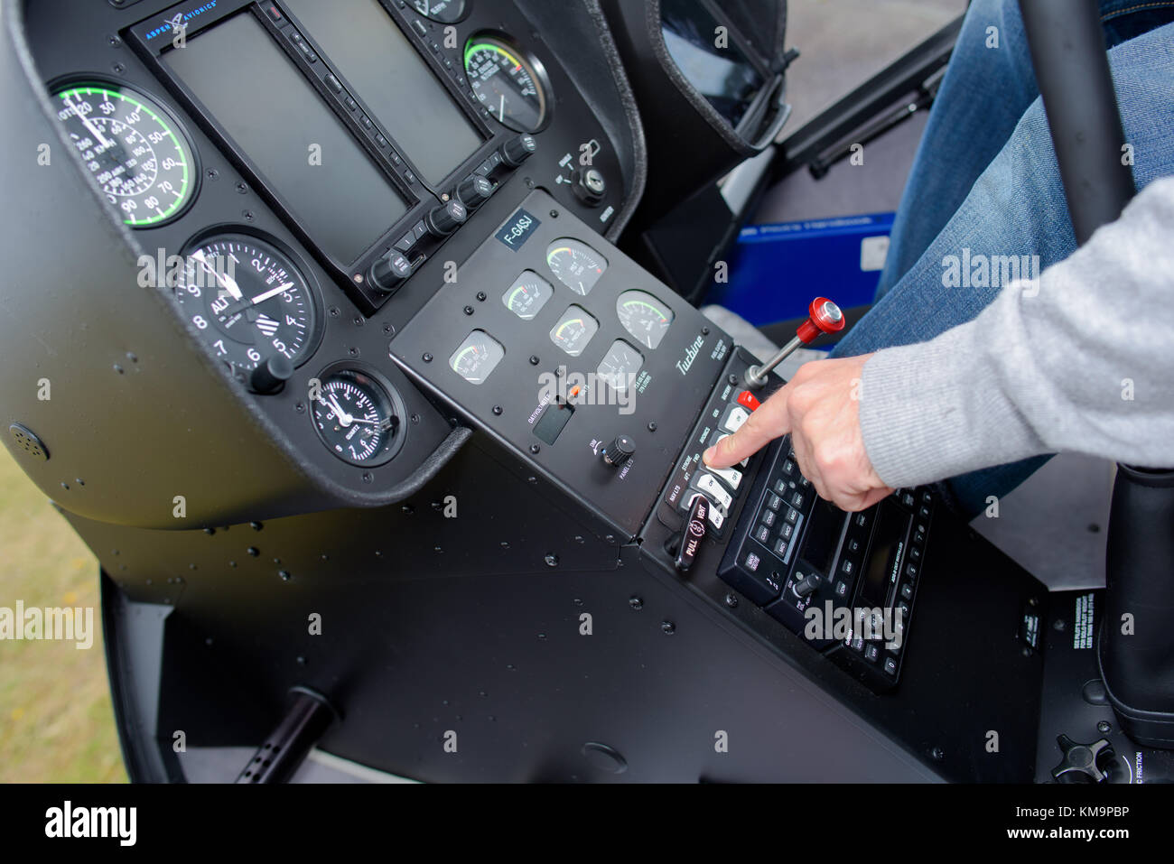 Man operating controls in cockpit Stock Photo - Alamy