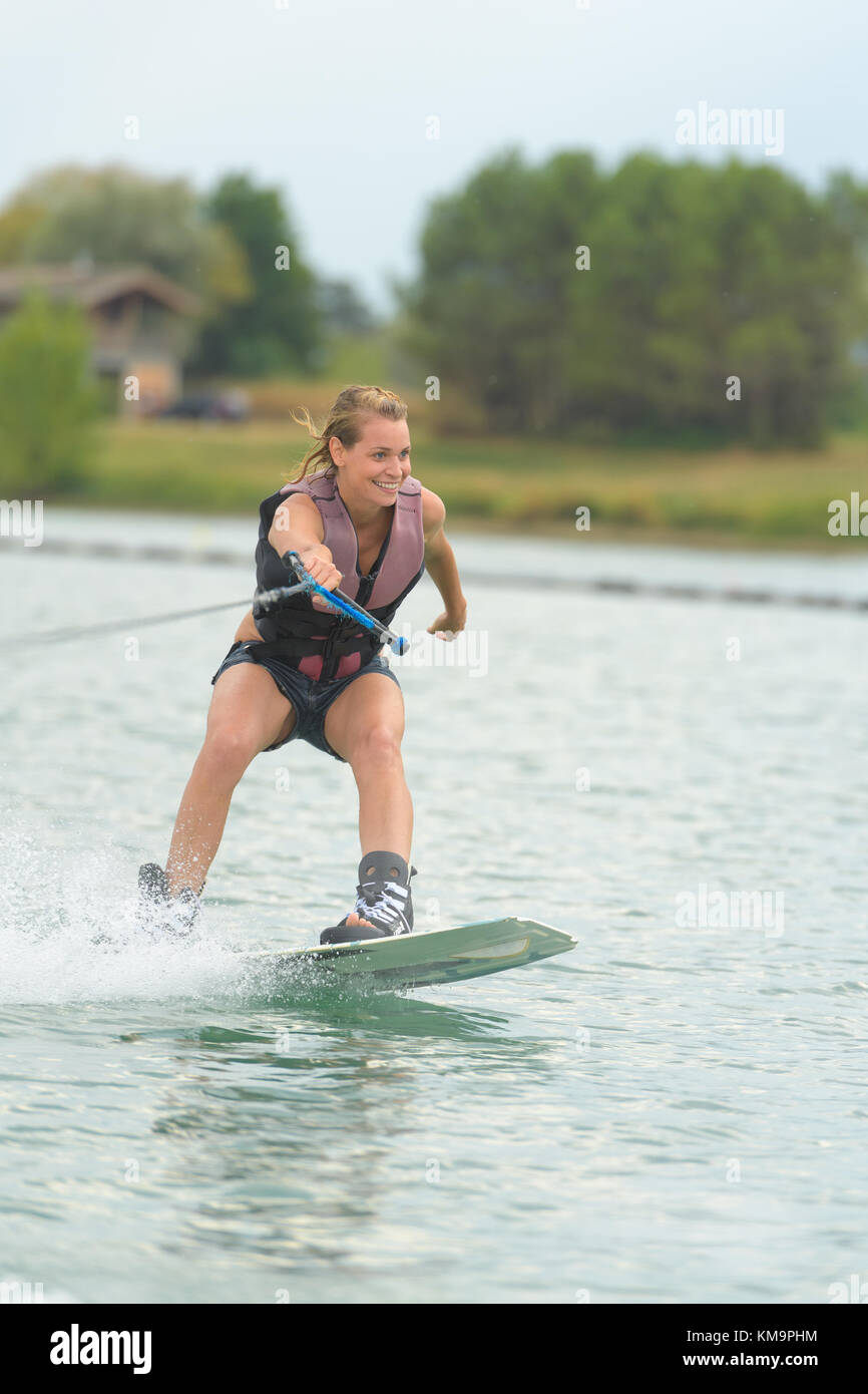 woman stunt on wakeboard on lake Stock Photo