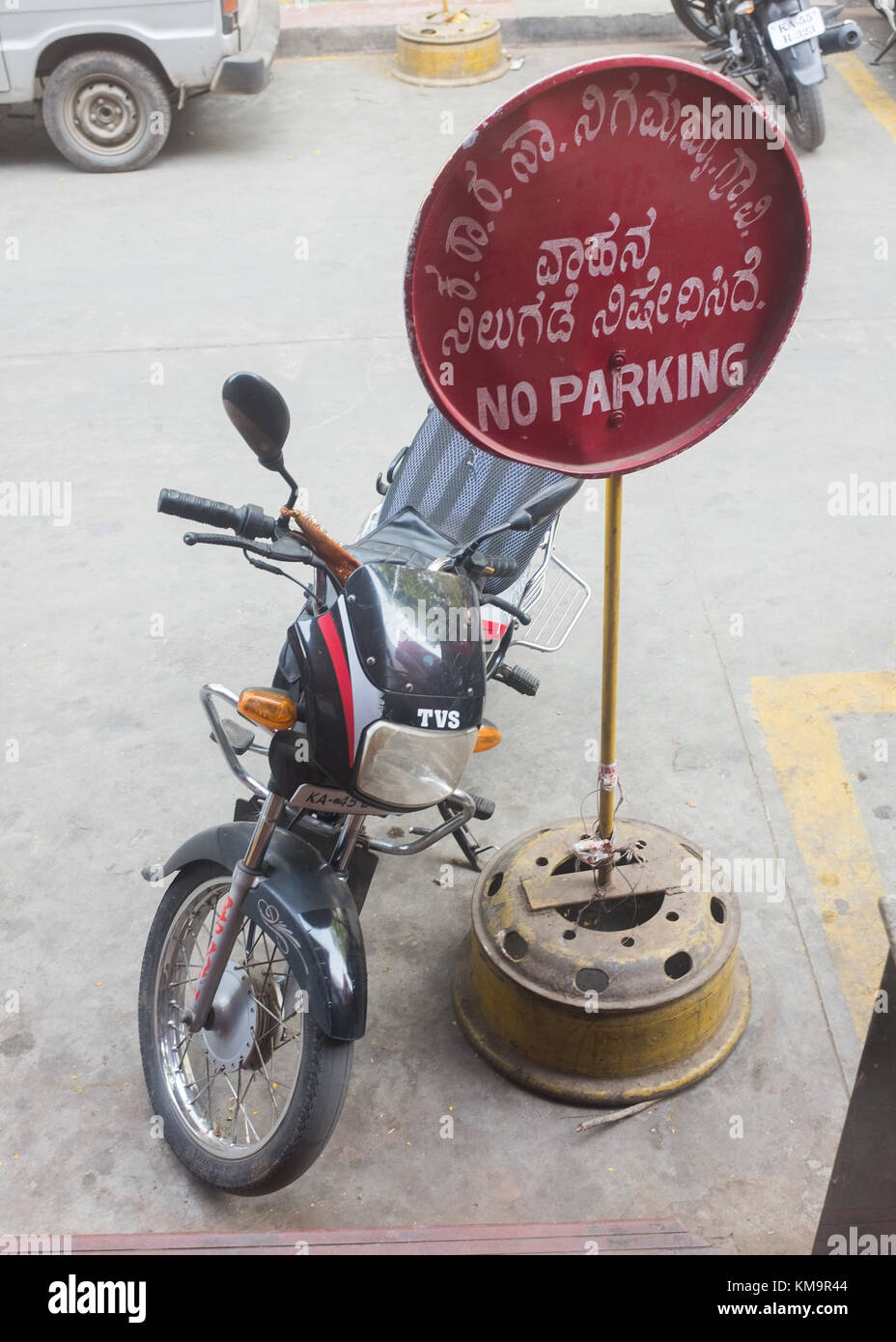 Motorbike parked next to no parking sign, Mysore, Karnataka, India. Stock Photo