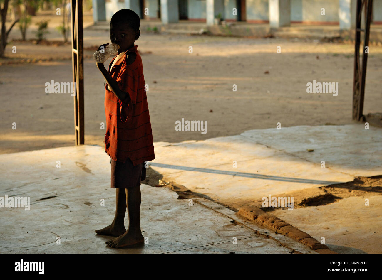 Boy with a plastic bottle in Kawaza village, Eastern Province, Zambia Stock Photo