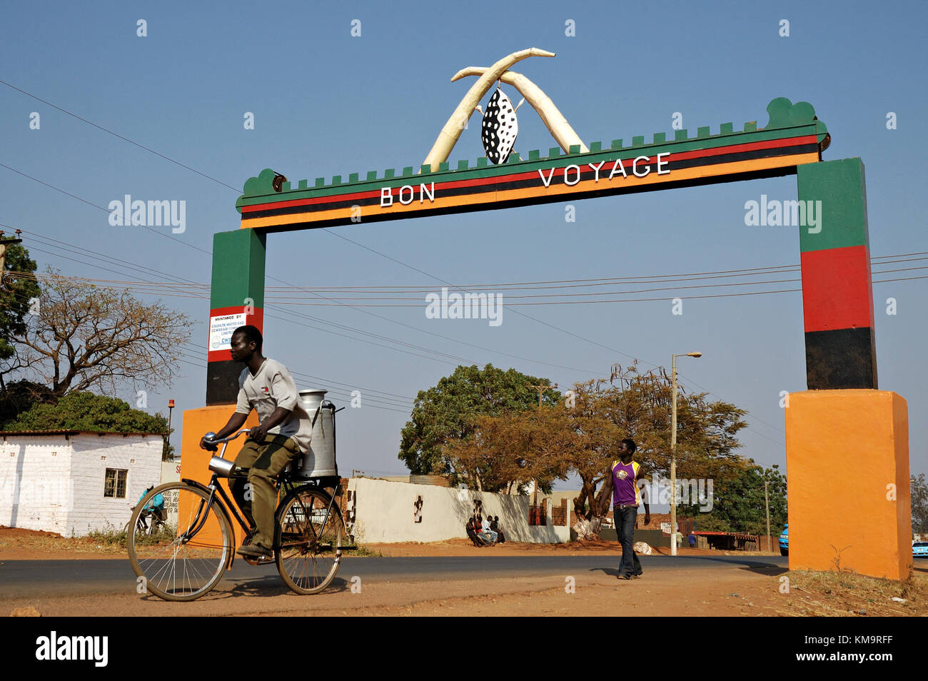 Man riding a bicycle in front of Chipata gate, Eastern Province, Zambia Stock Photo