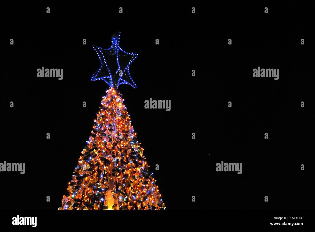 Christmas tree lit up with decorations and colorful lights. Suitable