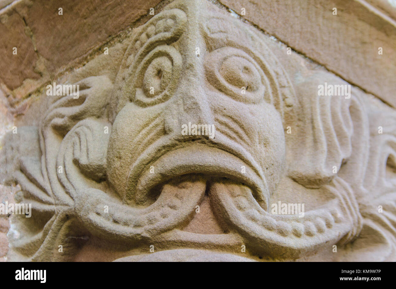 Romanesque carving of Green Man on the south door capital of Kilpeck church Herefordshire UK Stock Photo