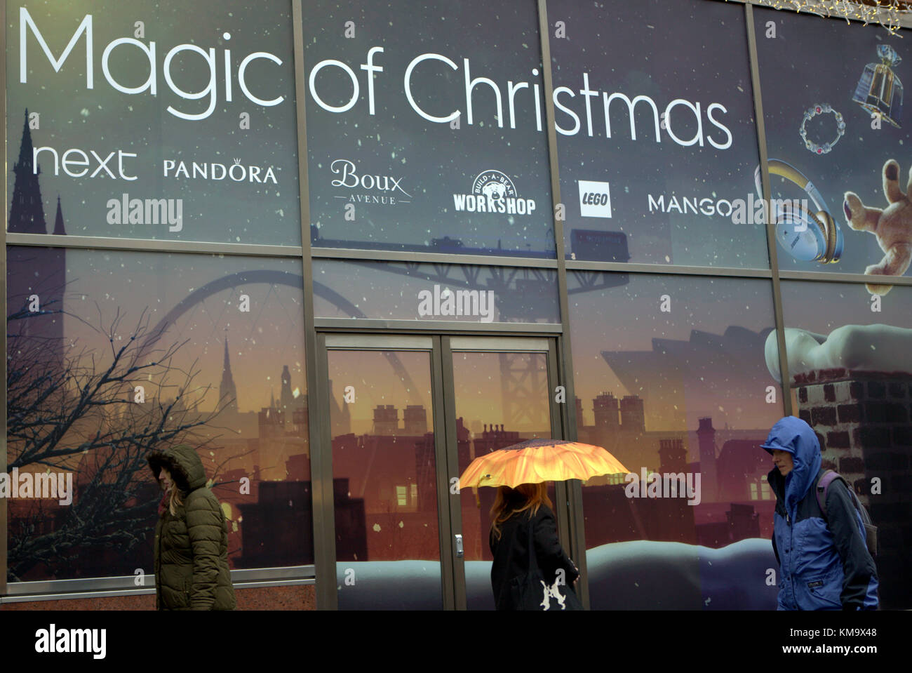 the magic of christmas shopping in Buchanan Galleries Glasgow in the rain with umbrellas Stock Photo