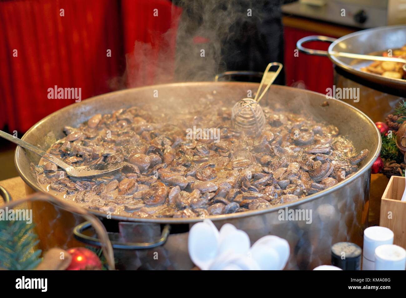 Mushrooms cooking in a large pan, Nottingham Christmas Market 2017 Stock Photo