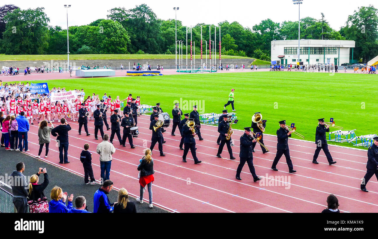 Garda band, Marching band leading the parade for community games athletics, Adults & Children walking around Morton stadium, Dublin Ireland Stock Photo