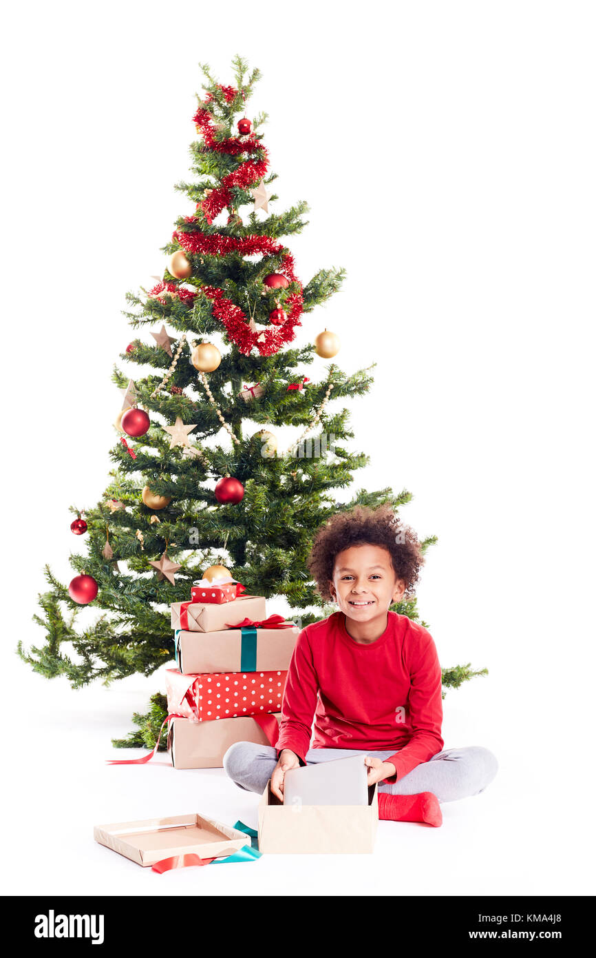 Boy unpacking Christmas gifts Stock Photo